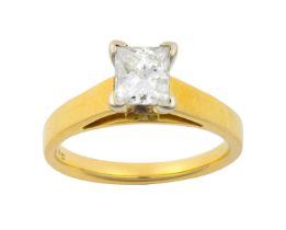 A Diamond Solitaire Ring the princess cut diamond in a white four claw setting, to a yellow