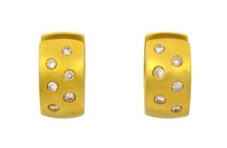 A Pair of Diamond Earrings the yellow hinged cuff inset with six round brilliant cut diamonds to the