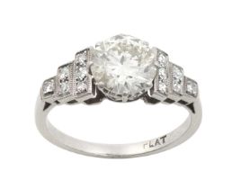 An Art Deco Diamond Ring the old cut diamond in a white claw setting, to stepped shoulders with