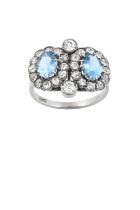 An Aquamarine and Diamond Double Cluster Ring two oval cut aquamarines in white claw settings within