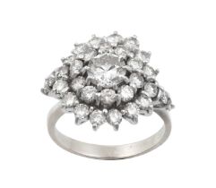 A Diamond Cluster Ring the central round brilliant cut diamond within a double stepped border of