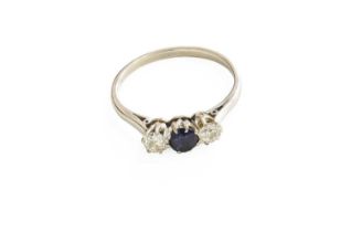 A Sapphire and Diamond Three Stone Ring, the central round cut sapphire flanked by old cut diamonds,