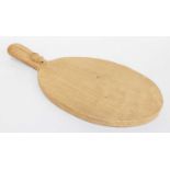 Workshop of Robert Mouseman Thompson (Kilburn): An English Oak Cheese Board, post 1960, of