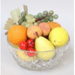 A collection of painted marble fruit in a cut glass bowl