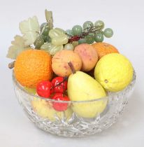 A collection of painted marble fruit in a cut glass bowl