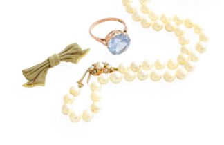 A Cultured Pearl Necklace, with a 9 carat gold split pearl clasp, length 47cm; A Bow Brooch, stamped
