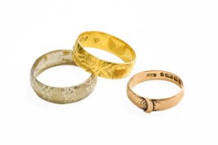 A 9 Carat Gold Buckle Ring, finger size N; A 9 Carat Gold Band Ring, finger size U; and An 18