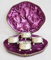 A Cased Set of Four Victorian Silver Salt-Cellars and Three Condiment-Spoons, by Edward Hutton,