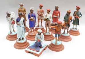 A Collection of Indian Painted Terracotta Figures, modelled as street traders, on titled stepped