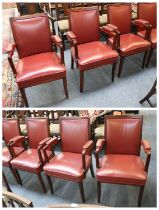 A Set of Six Teak Open Armchairs, upholstered in red leather