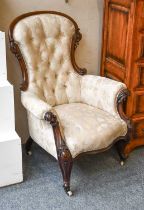 A Victorian Buttoned Spoon Back Armchair, with carved mahogany frame.