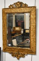 An Early 19th Century Gilt and Gesso Wall Mirror, with original bevelled edge plate, 103cm by 65cm