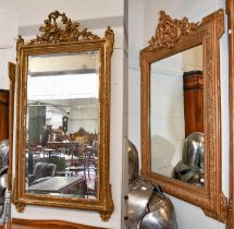 A 19th century Gilt Framed Mirror, surmounted by trophies and lorrells, with rectangular bevel