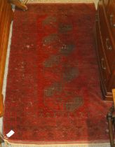 Afghan Rug, the claret field with four elephant foot guls enclosed by multiple borders, 220cm by