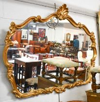 A Pair of 18th century Syle Gilt Framed Mirrors, the scrolling frames surmounted by shells, 122cm by