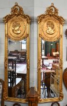 A Pair of Neo Rococo Style Gilt Framed Mirrors, with arched tops, decorated in relief with