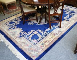 Chinese Carved Carpet, the royal blue field with a floral medallion, enclosed by ivory borders,