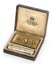 Asprey Silver Travelling Razor Set, mounted with yellow enamel to the hinged cover, cream silk and