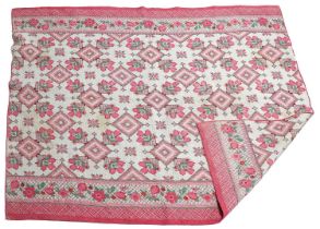 Circa 1930s Whole Cloth Quilt incorprating a vibrant pink floral design, with machine zigzag
