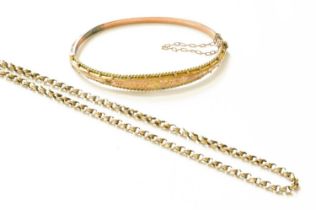 A 9 Carat Gold Hinged Bangle, inner measurements 5.9cm by 4.7cm (a.f.); and A Trace Link Chain, with