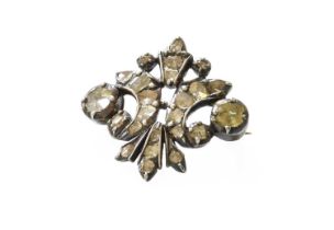 A Diamond Brooch, the stylised fleur de lys set throughout with lasque cut diamonds, in white collet