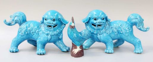A Pair of Chinese Porcelain Models of Lion Dogs, 20th century, decorated in turquoise glaze, 25cm