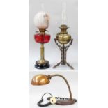 A Victorian Brass Based Oil Lamp, with cranberry glass reservoir, together with a similar Arts &