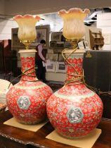 A Large Pair of Modern Chinese Porcelain Bottle Vases, red ground, enamelled with lotus scrolls,