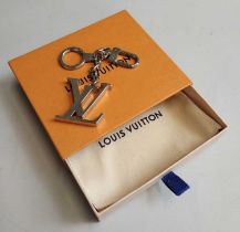 Louis Vuitton Initials Porte Cles Silver Tone Keyring/Handbag Charm, together with a fabric dust bag