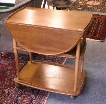 An Ercol Light Elm Two Tier Tea Trolley, 73cm by 46cm (closed) 77cm