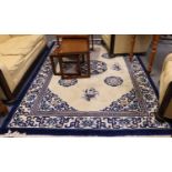 Chinese Carved Carpet, the cream field with a central roundel medallion enclosed by angular floral