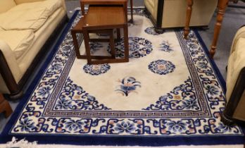 Chinese Carved Carpet, the cream field with a central roundel medallion enclosed by angular floral