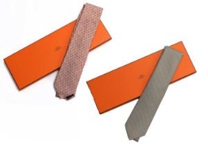 Hermés Silk Tie woven with white and blue horseshoes on a pale metallic orange ground, another woven