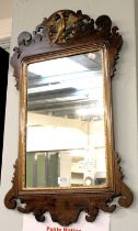 A George III Style Mahogany Fretwork Mirror, with gilt slip and surmounted by a ho-ho bird, 44cm