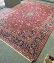 Kashan Carpet, the blood red field of palmettes and vines centered by an indigo medallion enclosed