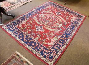 Indian Rug, the blood red field centered by a serrated panel enclosed by indigo borders, 207cm by
