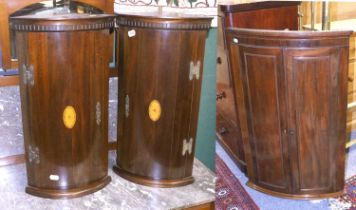 A George III Bow Fronted Mahogany Hanging Corner Cupboard, together with a pair of reproduction