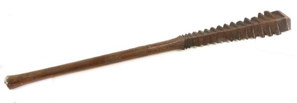 A 19th Century Samoan Talavalu Saw-Tooth War Club, of dense hardwood, the cylindrical haft carved