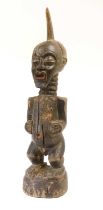 A Songye Power Figure, DRC, carved from dark stained wood, with red painted open mouth and animal