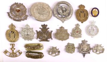 A Collection of Eighteen Military Badges, comprising a Victorian Border Regiment bandsmans sheet