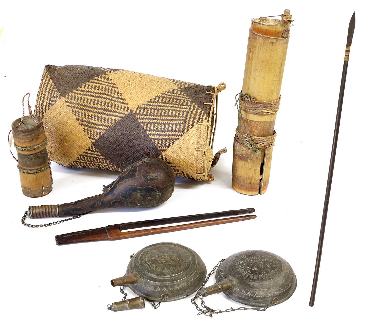 An Indonesian Sumpitan (Blowpipe), the bored-out wood haft set with a spearhead bound with wicker,