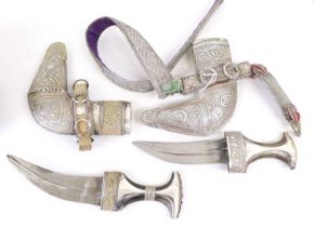 A 20th Century Omani Khanjar, the 17cm curved steel blade with raised medial ridge, the horn grip