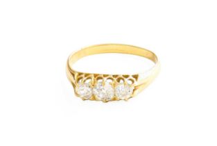 A Diamond Three Stone Ring, the old cut diamonds in yellow claw settings, to a plain polished shank,