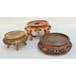 Three Chinese Hardwood Stands, carved & pierced, largest 23cm diameter (3)