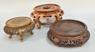 Three Chinese Hardwood Stands, carved & pierced, largest 23cm diameter (3)