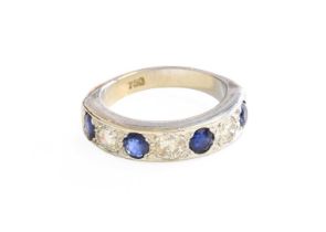 A Sapphire and Diamond Half Hoop Ring, four round cut sapphires alternate with three round brilliant