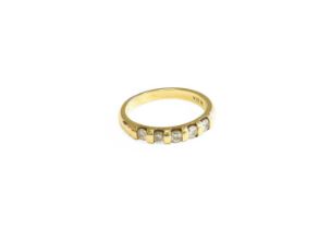 A 9 Carat Gold Diamond Five Stone Ring, the round brilliant cut diamonds in yellow bar settings,