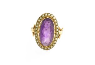 A 9 Carat Gold Amethyst and Split Pearl Ring, the oval cut amethyst within a border of split pearls,