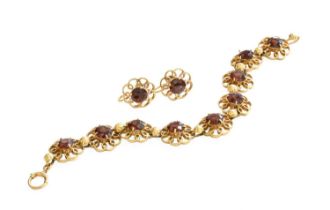 A 9 Carat Gold Garnet Bracelet, nine round cut garnets in yellow claw settings, within plain