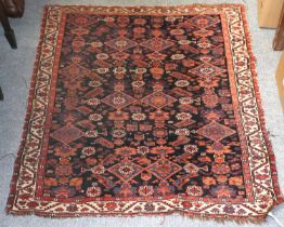 Fine Afshar Rug, the deep indigo field of flowerheads and diamond medallions enclosed by ivory